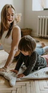 Mother and Son doing upward dog on yoga mat