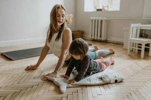 Mother and Son doing upward dog on yoga mat